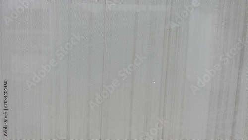 Photos A close-up view of a perforated steel plate featuring evenly spaced small holes across a durable metal surface