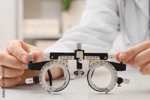 Optometrist adjusting phoro...