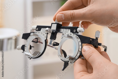 Optometrist adjusting phoro...