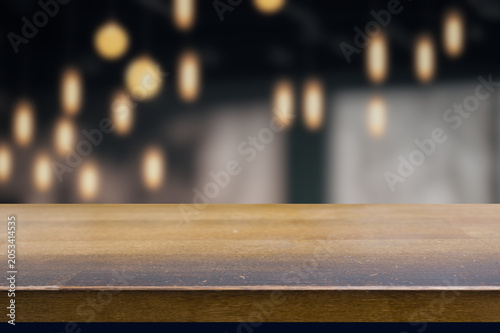 Empty dark wooden table in front of abstract blurred bokeh background of restaurant , can be used for display products.Mock up.