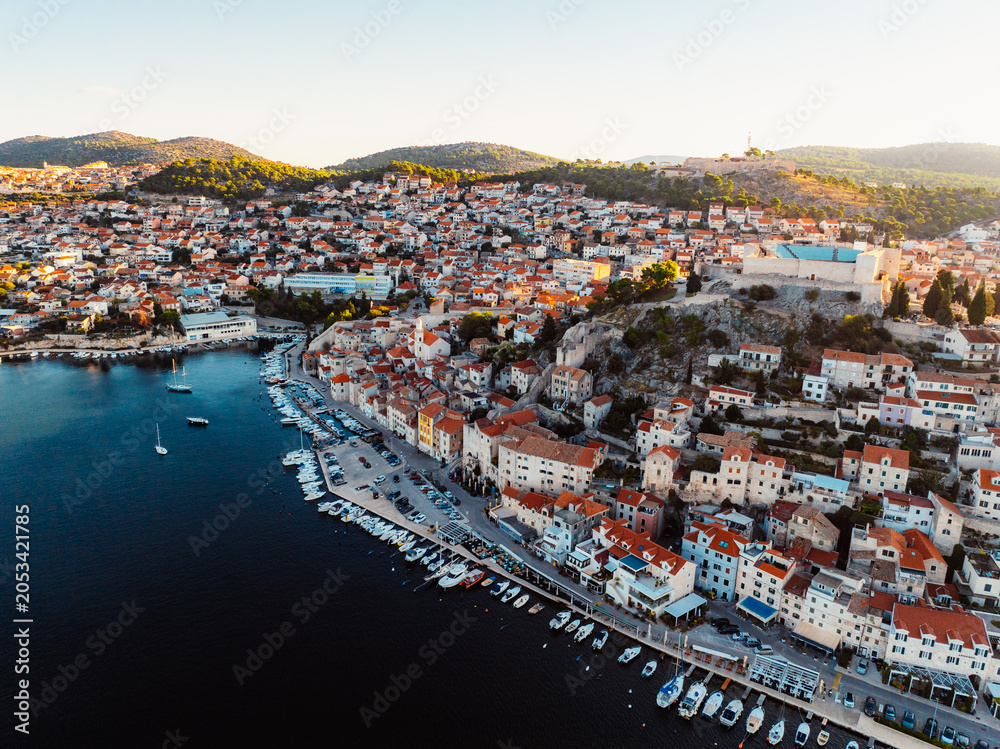 Naklejka premium Aerial panoramic view of Sibenik old town and St. James Cathedral at sunset, with St. Michael's Fortress and the Adriatic sea, Dalmatia, Croatia.