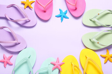 Colorful summer flip flops and starfish border on light purple background for vacation and beach concepts