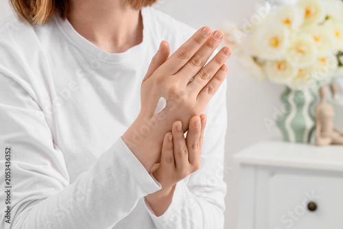 Woman applying moisturizing...