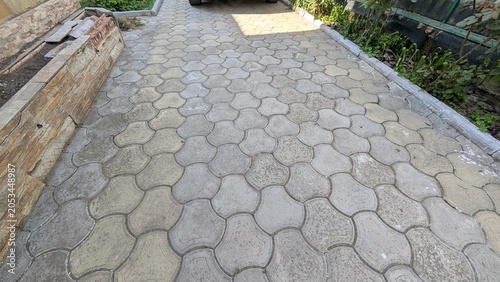 Fotografie Outdoor stone paver walkway in a yard with garden greenery