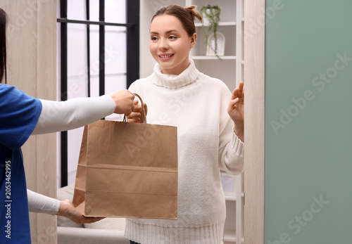 Happy woman receiving home ...