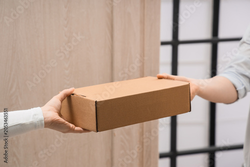 Hands exchanging cardboard ...