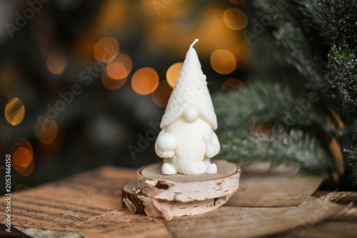 Unique handmade soy wax candles, cozy room with wooden decorations and Christmas lights in the background