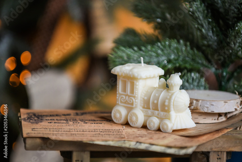 Unique handmade soy wax candles, cozy room with wooden decorations and Christmas lights in the background