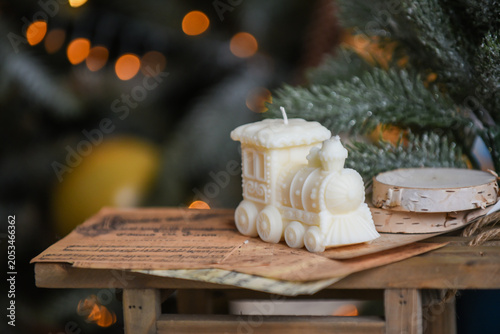 Unique handmade soy wax candles, cozy room with wooden decorations and Christmas lights in the background