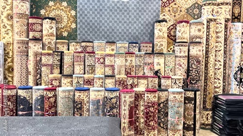 Multiple Persian carpets for sale at the store. Traditional hand-woven rugs with Vibrant colors.