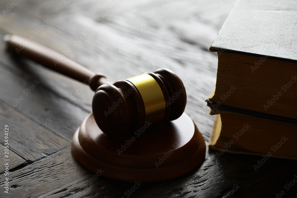 Obraz premium Judges gavel on wooden desk. Law firm concept.