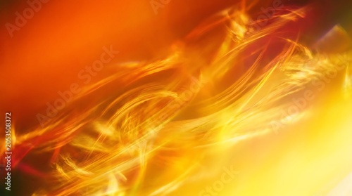 Abstract swirling orange and yellow light streaks in a fiery energetic motion blur background.