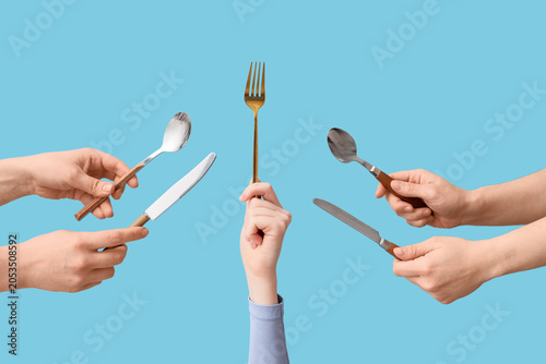 Golden fork held up by hand...