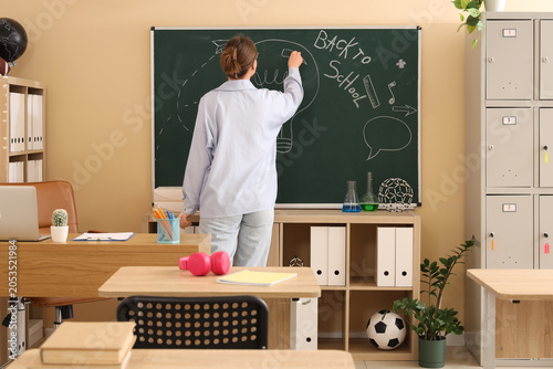 Teacher writing "back to sc...
