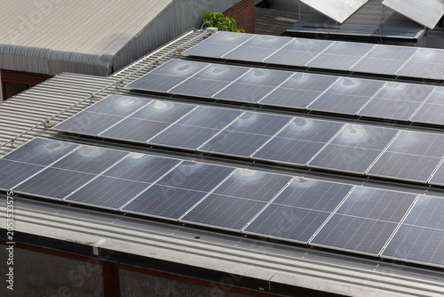Bild auf Leinwand Small puddles on solar panels because panels are mounted at too low tilt angles , the standing water can cause localized shading and reduce overall energy production