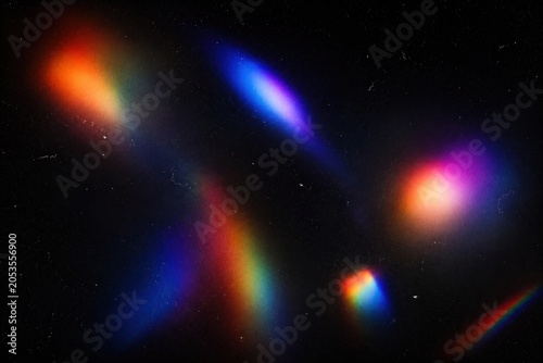 Abstract prism light leaks and rainbow lens flare effects on dark background for creative overlays and modern design.