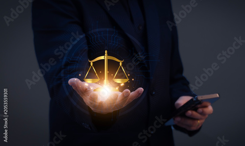 Hand presenting digital justice scale, representing AI ethics, fairness, data privacy, legal compliance, transparent decisions and responsible technology governance