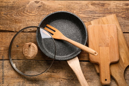 Фотография Kitchen utensils and cookware on rustic wooden tabletop, cooking and home food p