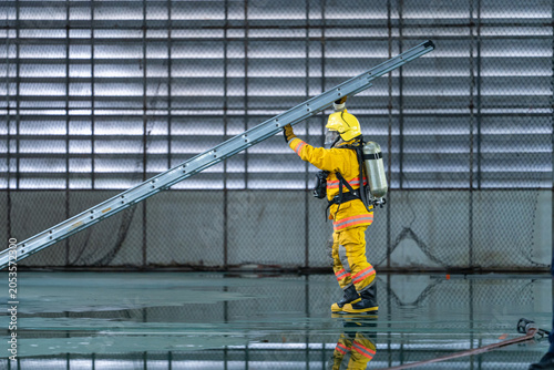 Firefighters Raising Ladder During Building Rescue and Emergency Response Training Exercise