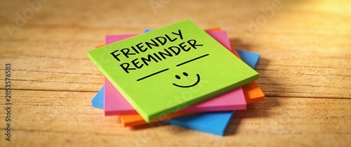 Friendly Reminder Note with Smiley Face on Wooden Desk