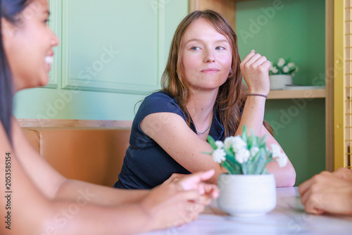 wo Female Friends Enjoying Conversation at Coffee Shop