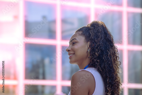 Young woman smiling, looking forward with hope and confidence in a business setting