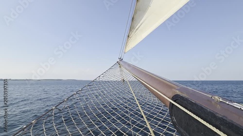 Classic Sailing Ship Bowsprit and Headsail Cutting Through Open Sea - Deck View