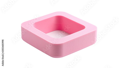 A close-up studio shot showcases a square, pink, foam-like object with an open center, resting on a stark black background