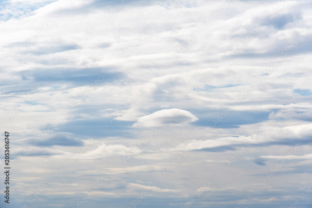 Obraz premium Beautiful white layered clouds on a soft blue sky background. Ethereal atmospheric texture for nature, travel, and religious commercial projects