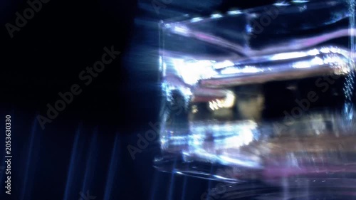 Luxury Crystal Glass Reflection Rotating with Abstract Light Refractions on Black Background