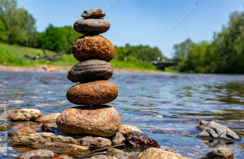 Canvas Print zen balance stones in water by a river