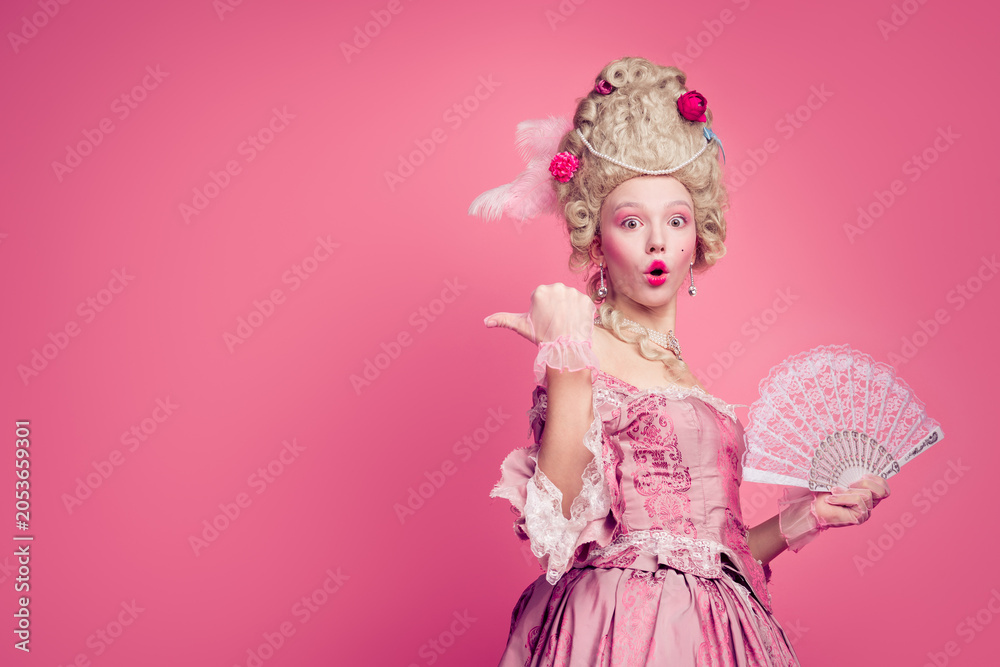 Fototapeta premium Photo of surprised shocked lady wearing classic renaissance dress corset point finger empty space isolated pink color background