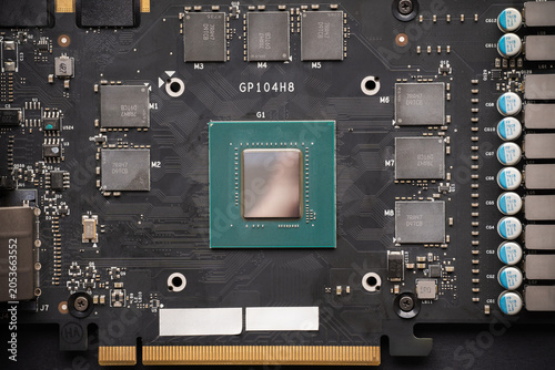 Photos Top view of a disassembled graphics card circuit board showing the central GPU chip marked GP104H8 surrounded by VRAM memory modules