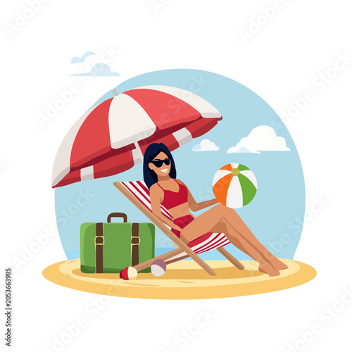 Woman relaxing on a beach chair with a beach ball and umbrella
