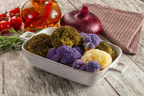 Photos Colorful broccoli and cauliflower florets in ceramic dish with fresh ingredients