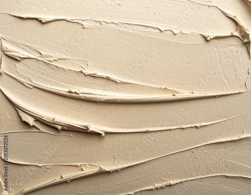 Swirls of creamy, smooth, beige cosmetic foundation texture, showing ridges