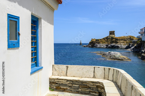 Andros Castle and Tourlitis Lighthouse of Chora seen from the chapel of Panagia Thalassini. Andros island, Cyclades, Greece