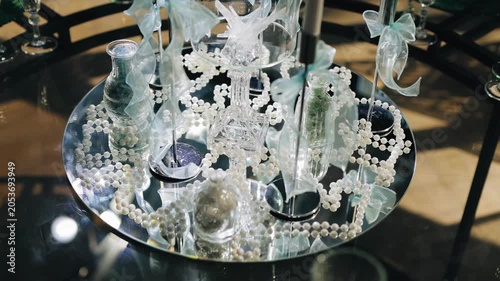 The beautiful mirrored table is decorated with various decorations. Different table decor