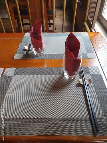 Chinese restaurant empty dinner placement with napkins and chopsticks