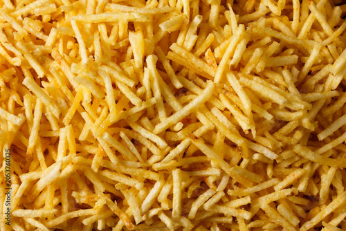 Background image with crispy fried potato sticks. A traditional Brazilian food