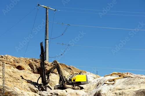 Drilling in progress with drilling machine in action in a quarry