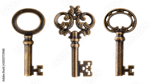 Fotografie Three antique ornate brass keys with decorative bow and bit
