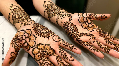 Hands with intricate henna tattoo designs
