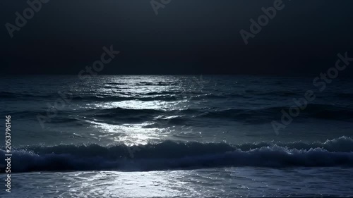 Ocean at night dark waters reflecting moonlight and creating serene ambiance