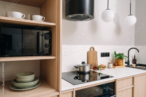 Konstfotografi Kitchen interior with built-in microwave, stove and cooker hood