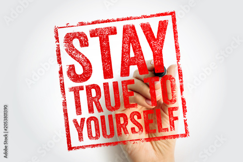 Photos STAY TRUE TO YOURSELF red stamp text held by a hand