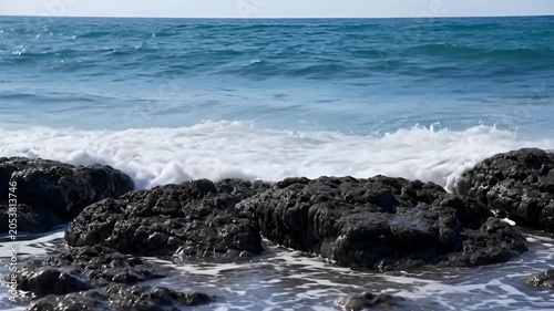 Ocean waves crashing on rocky shoreline creating a dynamic natural display