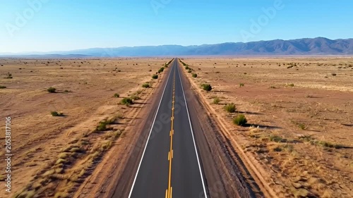 Open road perspective empty highway across desert landscape under sunlight