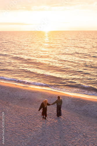 mother and daughter by the sea at sunset
