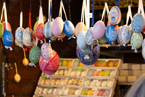 Фотография Colorful decorative Easter eggs hanging on display at a market, featuring intric